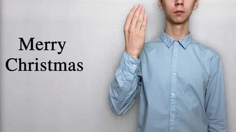 Deaf guy with Asian features in blue shirt on white background saying Xmas Stock-Footage 119284805
