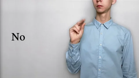 Deaf guy with Asian features in blue shirt on white background saying no . Show Stock Footage 119284818