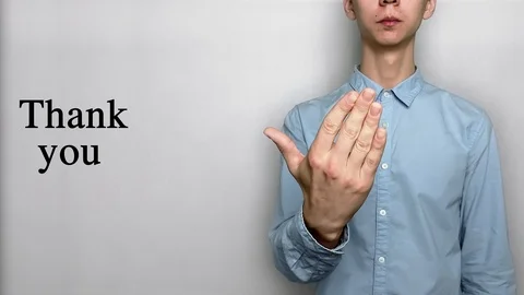 Deaf guy with Asian features in blue shirt on white background saying thank you Stock Footage 119284821