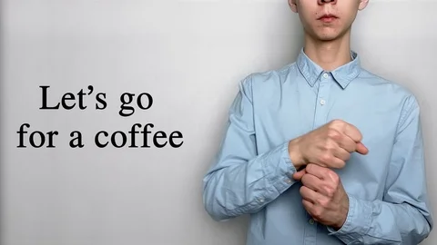 Deaf guy with Asian features in blue shirt on white background saying let's go Video stock 119314508