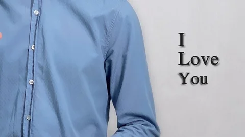 Deaf guy with Asian features in blue shirt on white background saying I love you Stock-Footage 121451306