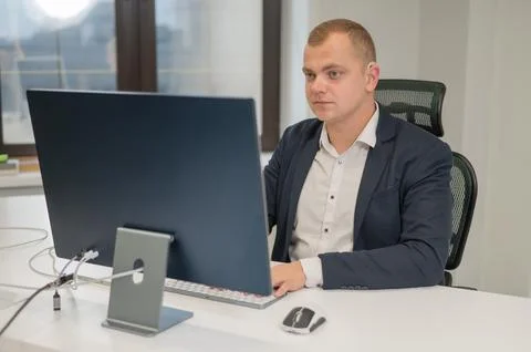 Deaf man working on a computer in the office. Stock Photos