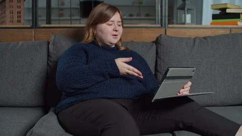 Deaf woman talking using sign language with tablet pc Stock Footage 122245699