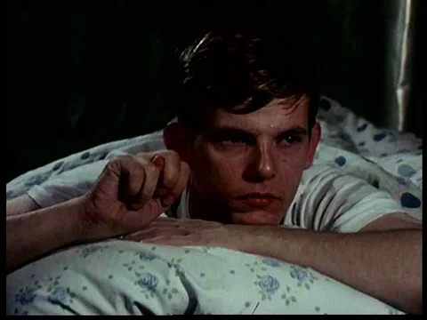 A deaf young man and a deaf young woman awaken in their respective bedrooms in Stock Footage 75267946
