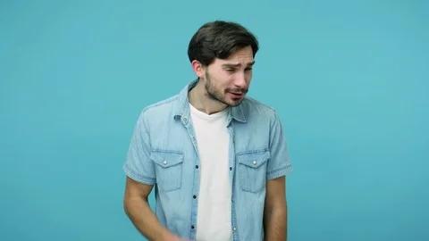 Deafness and hearing problems. Attentive bearded guy in jeans shirt keeping hand Video stock 126074417