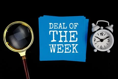 Deal Of The Week text on sticky note with magnifying glass and alarm clock .. Stock Photos