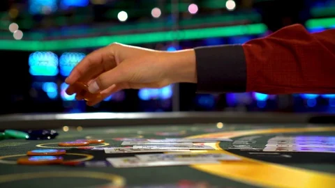Dealer give back win to the player and deals the cards to play three card poker Stock Footage 109067633