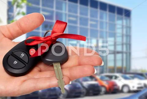 Dealer hand with a car key. Stock Photos
