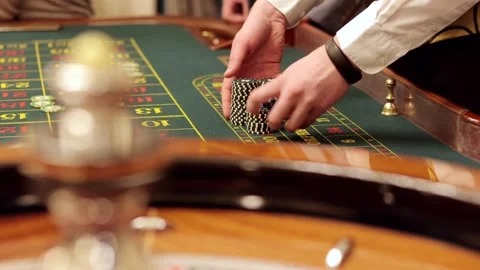 Dealer man placing chips for roulette in casino. Slow motion. Stock Footage 321675737
