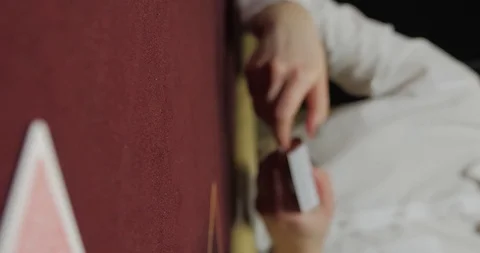 Dealer sitting in a casino at table while holding and distributing cards Vídeo Stock 126651593