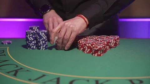 Dealer Stacking Chips Meticulously Today. Dealer Organizing Red Chips With Stock-Footage 344793784