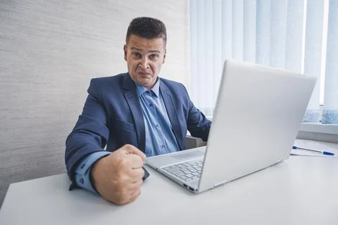 Dealing with anger at work. man feel anger at work. Businessman show fist in  Stock Photos