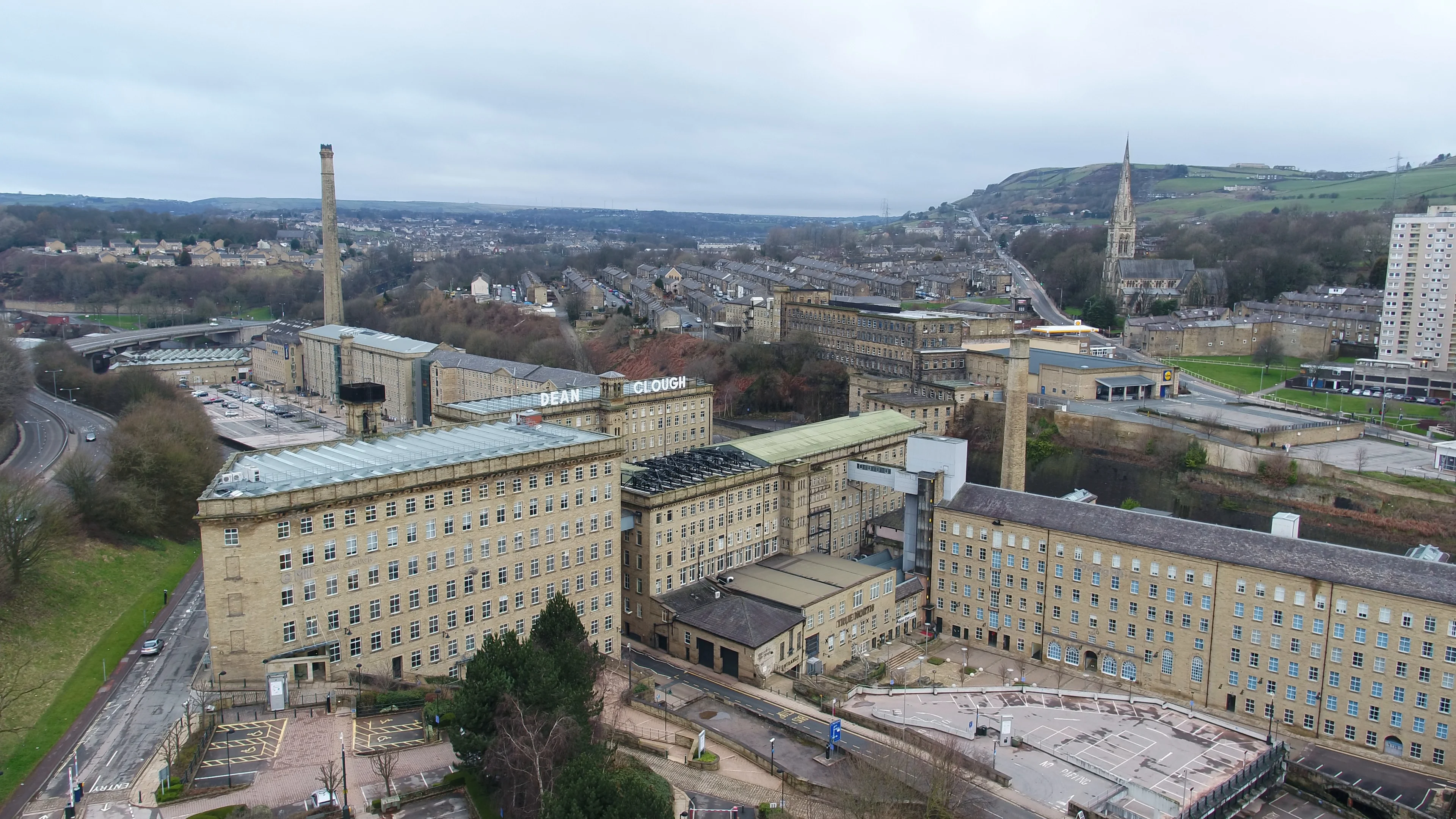 Aerial drone flight around a large industrial mill complex