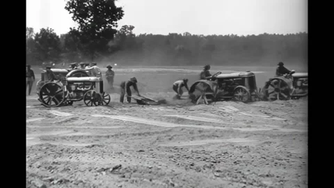 DEARBORN - 1922 - Farmers pull leveling sleds behind Fordson tractors to grade Stock Footage 308103960