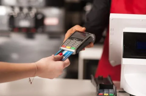 Debit card swiping on card-reader device Stock Photos