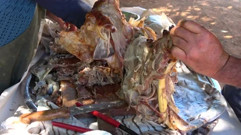 Deboning cooked roasted lamb with hands Video stock 156758930