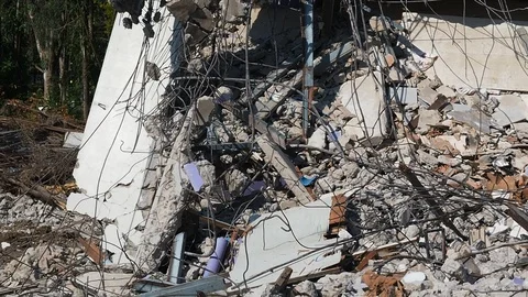 Debris and destroyed building that collapsed from the earthquake. Stock Footage 109039349