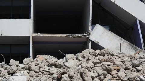 Debris and destroyed building that collapsed from the earthquake. Stock Footage 117843609