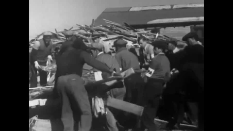 Debris is cleared and a piano is cleaned and sand is shoveled into a truck in Stock Footage 88707245