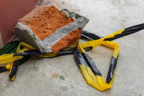 Debris composed of a large red brick fragment with attached concrete Stock Photos