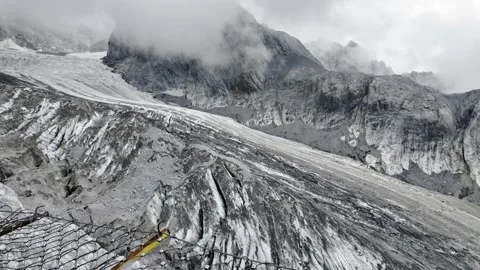 Debris Covered Glacier in Mountain Valley with Safety Fence Stock Footage 340131229