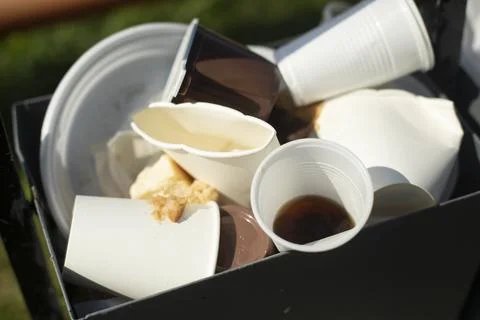 Debris in damage. Disposable tableware in trash. Discarded dishes. Stock Photos