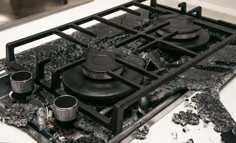 Debris from the explosion of a built-in gas hob in a glass ceramic hob in a k Stock Photos