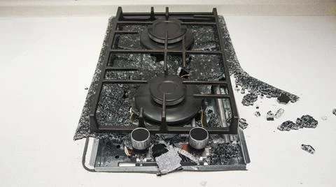 Debris from the explosion of a built-in gas hob in a glass ceramic hob in a k Stock Photos