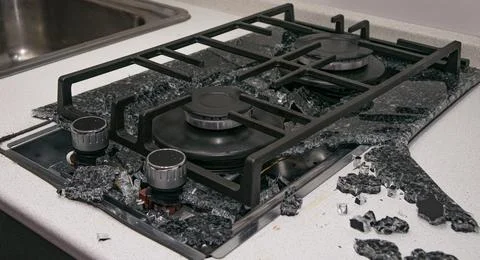 Debris from the explosion of a built-in gas hob in a glass ceramic hob in a k Stock Photos