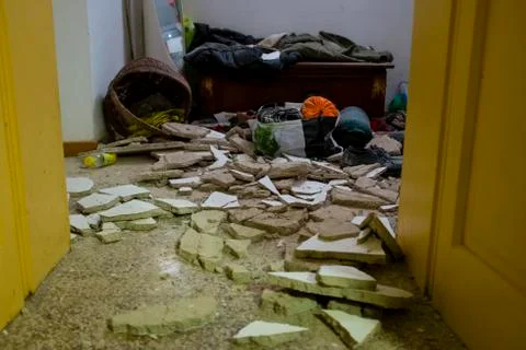 Debris fallen from the ceiling of a house cover objects of daily life Stock Photos