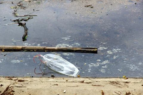 Debris in rivers pollutes waterways, causing polluted water. Stock Photos