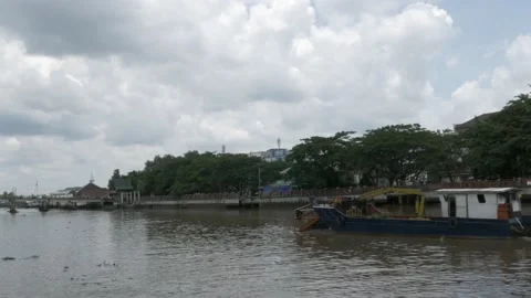 Debris skimmer removing trash and garbage on Martapura river Stock Footage 156995852