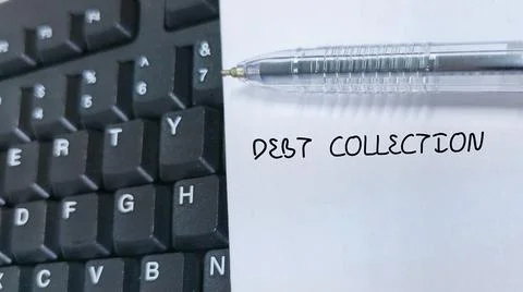 Debt Collection written on a note next to a computer keyboard and a pen Stock Photos