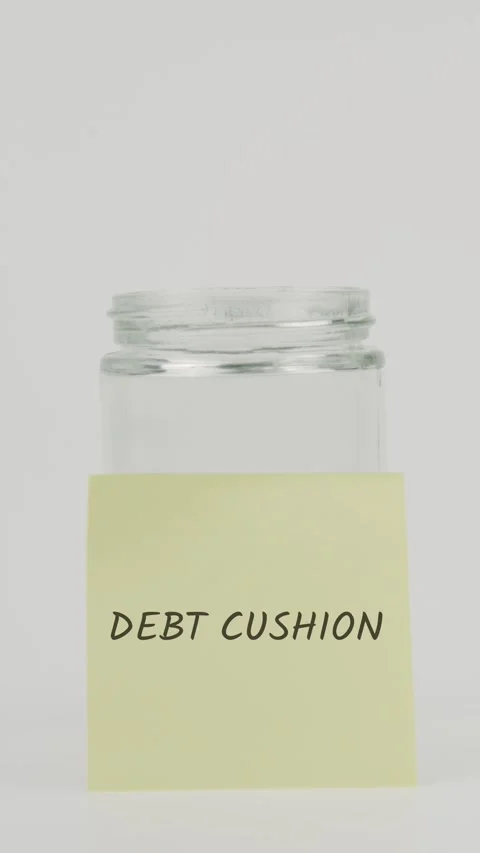 Debt cushion text or word on yellow sticky note attached to glass jar Stock Footage 311709088