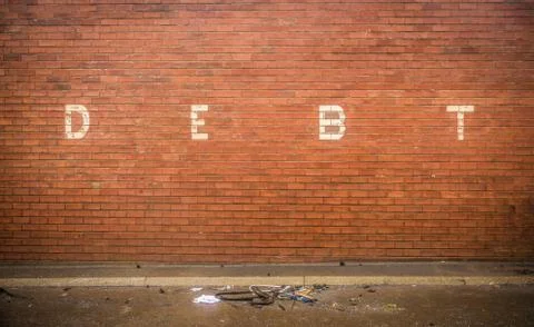 Debt On Red Brick Wall 스톡 사진