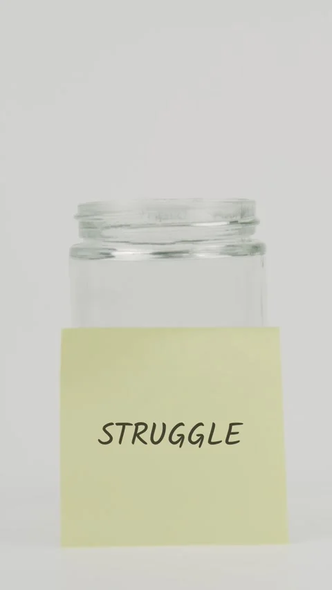 Debt text or word on yellow sticky note attached to glass jar with hand Stock Footage 311710209