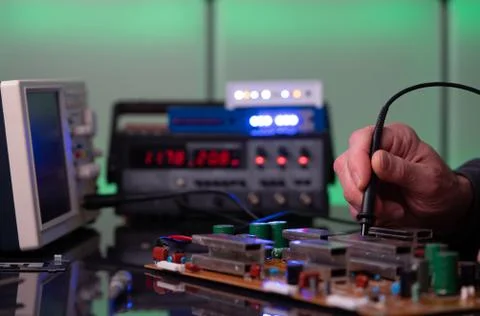 Debugging electronics device. PCB witch microcontroller in electronics labora Stock Photos