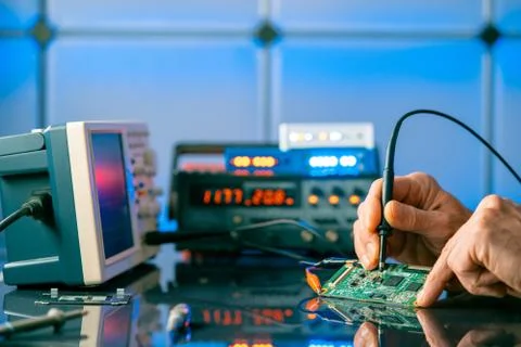 Debugging electronics device. PCB witch microcontroller in electronics labora Stock Photos