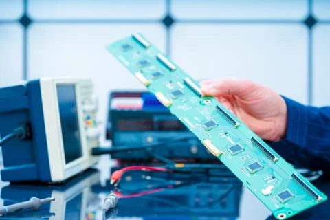 Debugging electronics device. PCB witch microcontroller in electronics labora Stock Photos