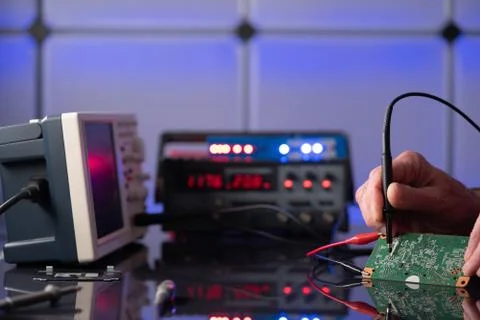 Debugging electronics device. PCB witch microcontroller in electronics labora Stock Photos