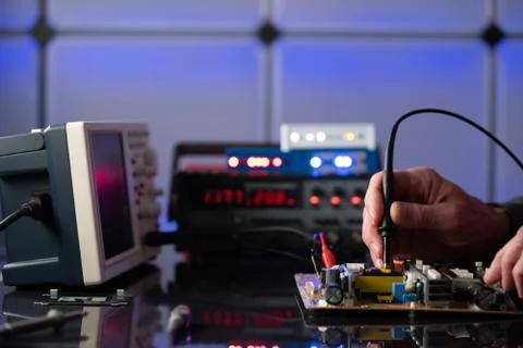 Debugging electronics device. PCB witch microcontroller in electronics labora Stock Photos