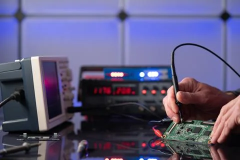 Debugging electronics device. PCB witch microcontroller in electronics labora Stock Photos