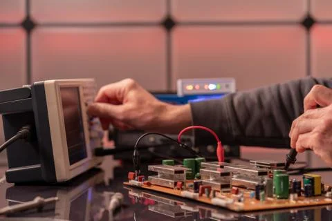 Debugging electronics device. PCB witch microcontroller in electronics labora Stock Photos