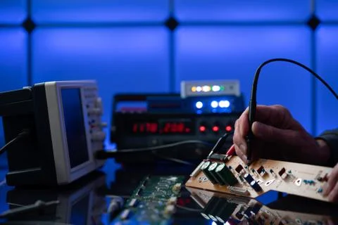 Debugging electronics device. PCB witch microcontroller in electronics labora Stock Photos