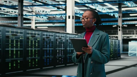 Debugging systems, tablet and female engineer walking in data center Stock Footage 329532593