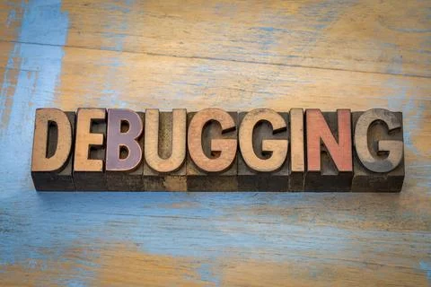Debugging  - word abstract in vintage letterpress wood type against grunge .. Stock Photos