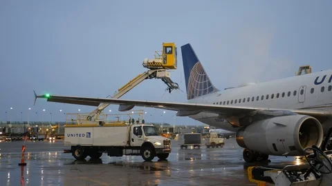 Dec 17 2016  / Chicago, USA: Deicing a United Airlines plane at O'Hare Stock Footage 105428558