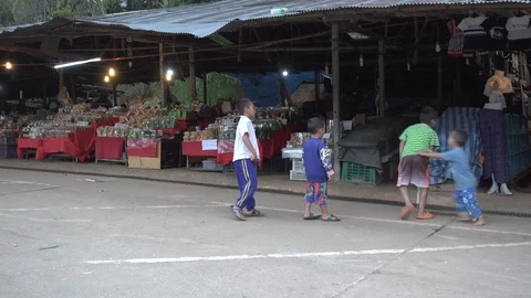Dec 17th, Mae Hong Son, Thailand: Children play at the market site Stock Footage 101204727