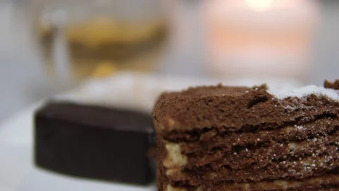 A decadent slice of chocolate layer cake presented beautifully on a plate Stock Footage 302672947