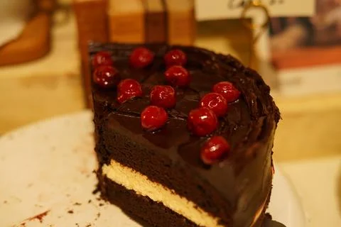 Decadent Slice of Chocolate Layer Cake with Cherries on Top Stock Photos